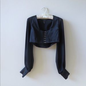 Long sleeve black crop top with mesh sleeves and silver embellishments